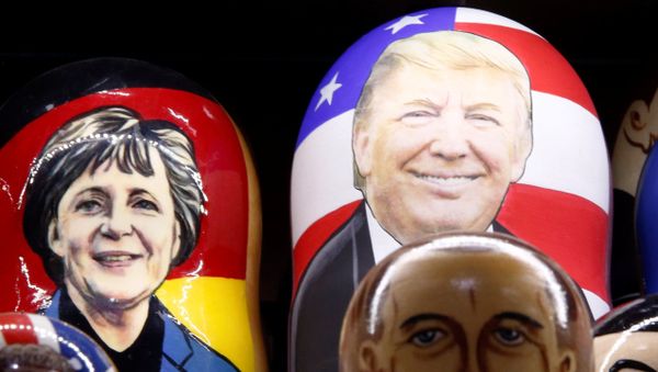 Painted Matryoshka dolls, or Russian nesting dolls, bearing the faces of German Chancellor Angela Merkel an US President-elect Donald Trump - Sputnik International