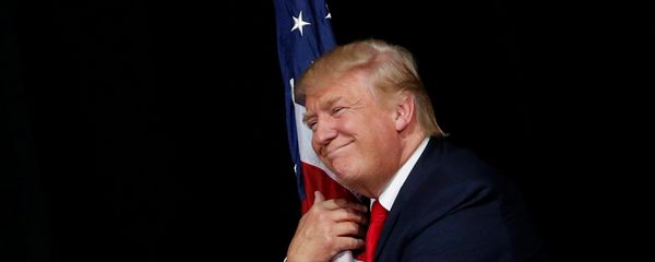 Donald Trump hugs a U.S. flag as he comes onstage to rally with supporters in Tampa, Florida, U.S. October 24, 2016 Donald Trump hugs a U.S. flag as he comes onstage to rally with supporters in Tampa, Florida, U.S. October 24, 2016 - Sputnik International