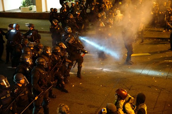 A police officer sprays the crowd with an irritant during a protest against the election of Republican Donald Trump as President of the United States in Portland, Oregon, U.S. November 12, 2016. - Sputnik International