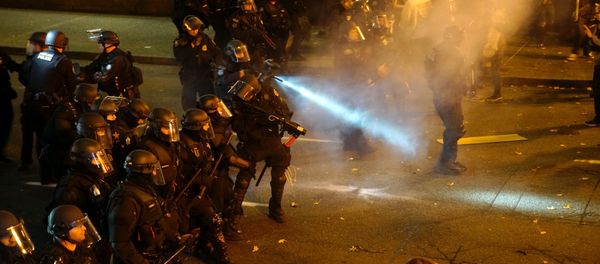 A police officer sprays the crowd with an irritant during a protest against the election of Republican Donald Trump as President of the United States in Portland, Oregon, U.S. November 12, 2016. - Sputnik International