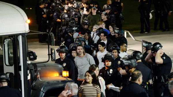 Protestors are detained by Los Angeles Police Department officers after a march and rally against the election of Republican Donald Trump as President of the United States in Los Angeles, California, U.S - Sputnik International