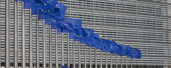 Workers adjust the EU flags in front of EU headquarters in Brussels. (File) - Sputnik International
