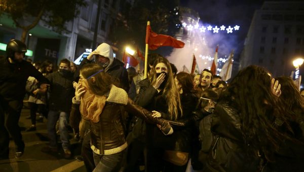 Protesters run away from teargas as they clash with riot police during a demonstration against the visit of U.S President Barack Obama, in Athens, Greece Protesters run away from teargas as they clash with riot police during a demonstration against the visit of U.S President Barack Obama, in Athens, Greece - Sputnik International