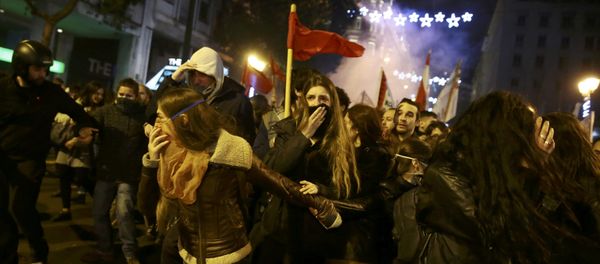 Protesters run away from teargas as they clash with riot police during a demonstration against the visit of U.S President Barack Obama, in Athens, Greece - Sputnik International