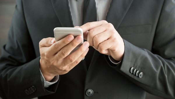 A man holding a phone A man holding a phone - Sputnik International