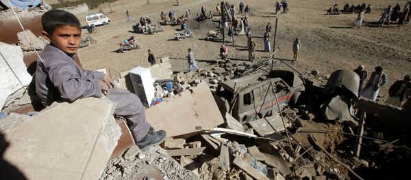 A boy looks at the camera as he sits on the wreckage of a house destroyed by a Saudi-led air strike on the outskirts of Sanaa, Yemen, November 13, 2016 - Sputnik International