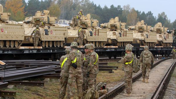 Members of the US Army 1st Brigade, 1st Cavalry Division, unload heavy combat equipment including Bradley Fighting Vehicles at the railway station near the Rukla military base in Lithuania, on October 4, 2014 Members of the US Army 1st Brigade, 1st Cavalry Division, unload heavy combat equipment including Bradley Fighting Vehicles at the railway station near the Rukla military base in Lithuania, on October 4, 2014 - Sputnik International
