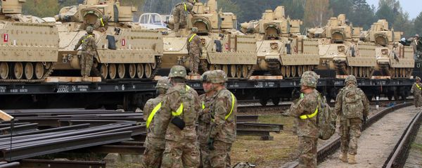 Members of the US Army 1st Brigade, 1st Cavalry Division, unload heavy combat equipment including Bradley Fighting Vehicles at the railway station near the Rukla military base in Lithuania, on October 4, 2014 Members of the US Army 1st Brigade, 1st Cavalry Division, unload heavy combat equipment including Bradley Fighting Vehicles at the railway station near the Rukla military base in Lithuania, on October 4, 2014 - Sputnik International
