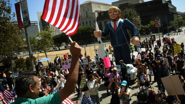 This file photo taken on May 01, 2016 shows Members of the 'Full Rights for Immigrants Coalition' displaying a giant effigy of US Republican Party presidential hopeful Donald Trump during a protest on May Day in Los Angeles, California on May 1, 2016 This file photo taken on May 01, 2016 shows Members of the 'Full Rights for Immigrants Coalition' displaying a giant effigy of US Republican Party presidential hopeful Donald Trump during a protest on May Day in Los Angeles, California on May 1, 2016 - Sputnik International