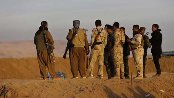 Kurdish Peshmerga fighters stand at a crossing point where Iraqis fleeing the fighting between Iraqi forces and Islamic State militants cross to the Kurdish controlled area, in the Nineveh plain, northeast of Mosul, Thursday, Nov. 17, 2016 Kurdish Peshmerga fighters stand at a crossing point where Iraqis fleeing the fighting between Iraqi forces and Islamic State militants cross to the Kurdish controlled area, in the Nineveh plain, northeast of Mosul, Thursday, Nov. 17, 2016 - Sputnik International
