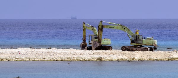 Two excavators are pictured at a construction site on Taiping island in the Spratly chain in the South China Sea on March 23, 2016 Two excavators are pictured at a construction site on Taiping island in the Spratly chain in the South China Sea on March 23, 2016 - Sputnik International