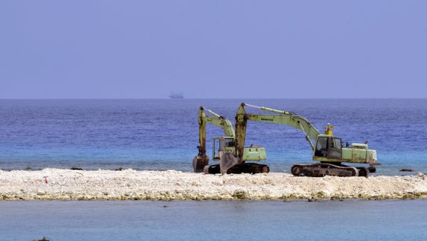 Two excavators are pictured at a construction site on Taiping island in the Spratly chain in the South China Sea on March 23, 2016 Two excavators are pictured at a construction site on Taiping island in the Spratly chain in the South China Sea on March 23, 2016 - Sputnik International