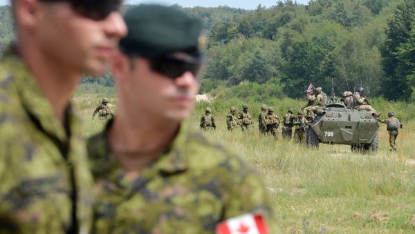 Canadian military instructors look on during Ukrainian military exercises at the International Peacekeeping and Security Center in Yavoriv, near Lviv(File) Canadian military instructors look on during Ukrainian military exercises at the International Peacekeeping and Security Center in Yavoriv, near Lviv(File) - Sputnik International