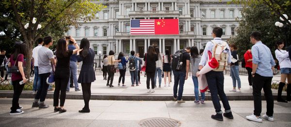China's flag is displayed next to the American flag on the side of the Old Executive Office Building on the White House complex in Washington (File) - Sputnik International