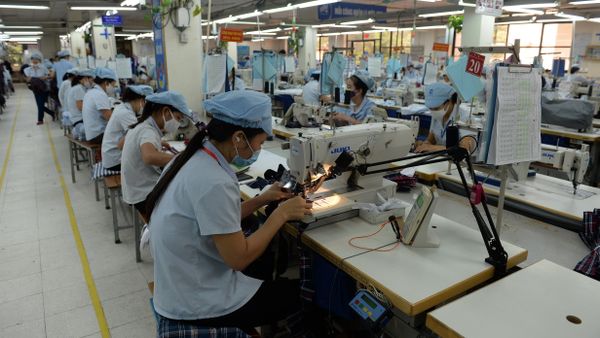 This picture taken on October 20, 2015 shows female workers on a production line at the Garment 10 Company in the outskirts of Hanoi This picture taken on October 20, 2015 shows female workers on a production line at the Garment 10 Company in the outskirts of Hanoi - Sputnik International