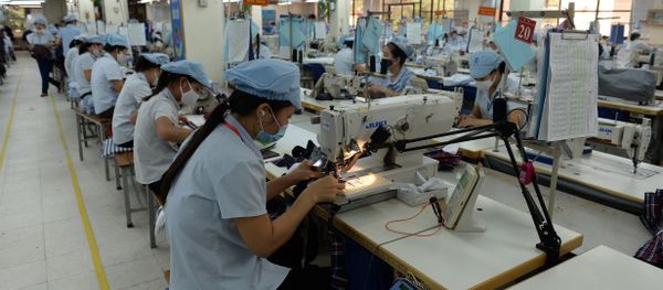 This picture taken on October 20, 2015 shows female workers on a production line at the Garment 10 Company in the outskirts of Hanoi This picture taken on October 20, 2015 shows female workers on a production line at the Garment 10 Company in the outskirts of Hanoi - Sputnik International