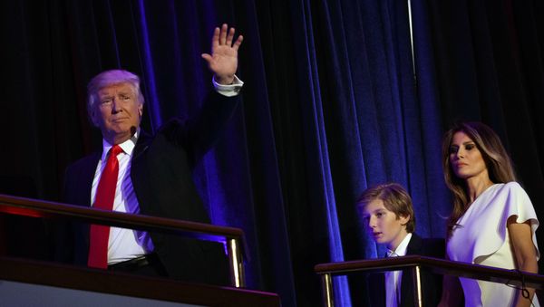 President-elect Donald Trump, left, walks with his son Barron, center, and wife Melania, to speak at an election night rally, Wednesday, Nov. 9, 2016, in New York - Sputnik International