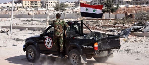 Members of Syrian pro-government forces drive their pick-up in the village of Minyan, west of Aleppo, after they retook the area from rebel fighters on November 12, 2016 - Sputnik International