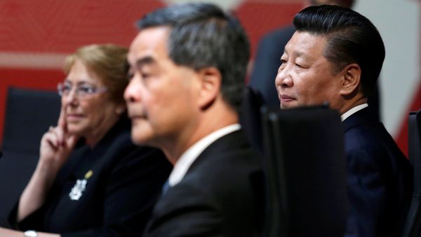 Chile's President Michelle Bachelet (L), China's President Xi Jinping (R) and Hong Kong Chief Executive Leung Chun-ying sit together during the APEC (Asia-Pacific Economic Cooperation) Summit in Lima, Peru Chile's President Michelle Bachelet (L), China's President Xi Jinping (R) and Hong Kong Chief Executive Leung Chun-ying sit together during the APEC (Asia-Pacific Economic Cooperation) Summit in Lima, Peru - Sputnik International