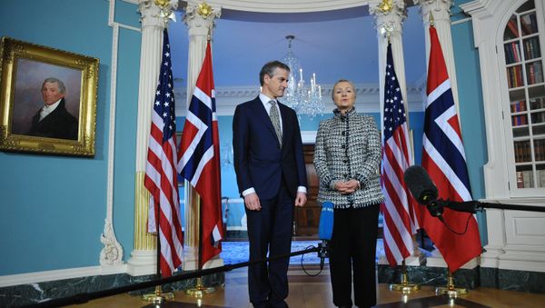 Hillary Clinton speaks to the press as Norwegian Foreign Minister Jonas Gahr looks on ahead of a bilateral meeting at the State Department January 10, 2012 in Washington, DC. Hillary Clinton speaks to the press as Norwegian Foreign Minister Jonas Gahr looks on ahead of a bilateral meeting at the State Department January 10, 2012 in Washington, DC. - Sputnik International