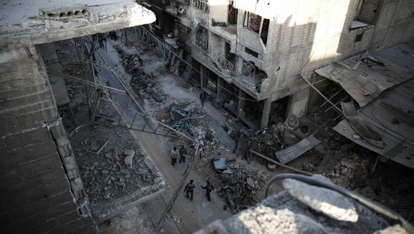 Syrians walk on a heavily damaged street in the rebel-held town of Douma, on the eastern outskirts of the capital Damascus Syrians walk on a heavily damaged street in the rebel-held town of Douma, on the eastern outskirts of the capital Damascus - Sputnik International