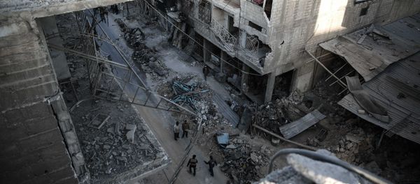 Syrians walk on a heavily damaged street in the rebel-held town of Douma, on the eastern outskirts of the capital Damascus Syrians walk on a heavily damaged street in the rebel-held town of Douma, on the eastern outskirts of the capital Damascus - Sputnik International