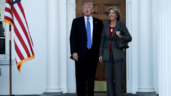 US President-elect Donald Trump (L) stands with Betsy DeVos after their meeting at the main clubhouse at Trump National Golf Club in Bedminster, New Jersey, US, November 19, 2016. US President-elect Donald Trump (L) stands with Betsy DeVos after their meeting at the main clubhouse at Trump National Golf Club in Bedminster, New Jersey, US, November 19, 2016. - Sputnik International