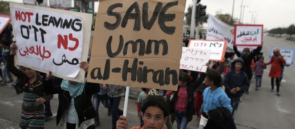 Bedouins hold placards during a protest against a plan to uproot the Umm Al-Hiran village, which is not recognized by the Israeli government, in the southern Israeli city of Beersheva in the Negev desert (File) Bedouins hold placards during a protest against a plan to uproot the Umm Al-Hiran village, which is not recognized by the Israeli government, in the southern Israeli city of Beersheva in the Negev desert (File) - Sputnik International