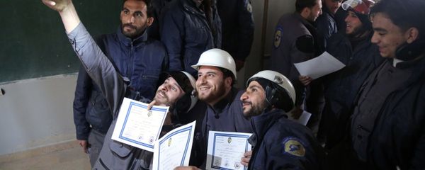 Members of the Syrian Civil Defence, known as the White Helmets, take a selfie with their certificates after taking part in a training session in the rebel-held eastern Ghouta area, east of the capital Damascus, on November 22, 2016 - Sputnik International