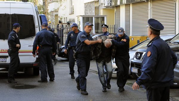 A man is escorted by Montenegrin police officers to the special court in Podgorica on October 16, 2016 A man is escorted by Montenegrin police officers to the special court in Podgorica on October 16, 2016 - Sputnik International