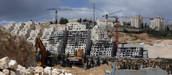 A general view taken on March 29, 2016 shows Israeli construction cranes and excavators at a building site of new housing units in the Jewish settlement of Neve Yaakov, in the northern area of east Jerusalem A general view taken on March 29, 2016 shows Israeli construction cranes and excavators at a building site of new housing units in the Jewish settlement of Neve Yaakov, in the northern area of east Jerusalem - Sputnik International