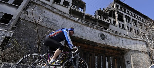 A man rides his bike on March 22, 2009 past the building of the former federal Interior Ministry in Belgrade, which was destroyed during the 1999 NATO air campaign against Serbia and Montenegro A man rides his bike on March 22, 2009 past the building of the former federal Interior Ministry in Belgrade, which was destroyed during the 1999 NATO air campaign against Serbia and Montenegro - Sputnik International