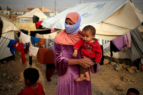 A woman who fled from Mosul carries her five-month-old daughter Ritadj, who was born under Islamic State rule and has no identity documents recognised by Iraqi authorities, in Debaga refugee camp, Iraq November 10, 2016 A woman who fled from Mosul carries her five-month-old daughter Ritadj, who was born under Islamic State rule and has no identity documents recognised by Iraqi authorities, in Debaga refugee camp, Iraq November 10, 2016 - Sputnik International