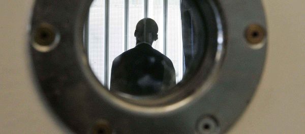 A security guard is seen through a small security window, in a room in the long-term wing at the new Colnbrook Immigration Removal Centre near London's Heathrow Airport, Thursday Sept. 16, 2004 A security guard is seen through a small security window, in a room in the long-term wing at the new Colnbrook Immigration Removal Centre near London's Heathrow Airport, Thursday Sept. 16, 2004 - Sputnik International