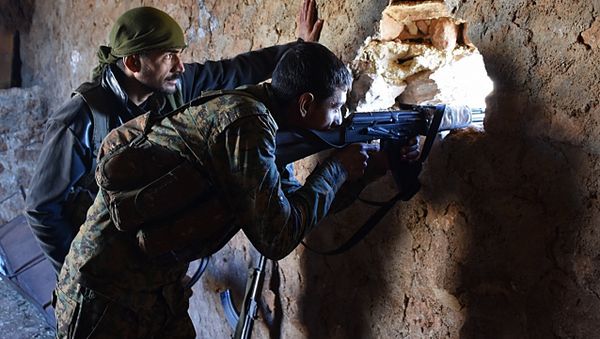 A fighter from the Syrian pro-government forces mans a riffle inside a damaged house in the recently recaptured village of Joubah during an offensive towards the area of Al-Bab in Aleppo province, on November 25, 2016 - Sputnik International