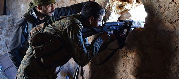 A fighter from the Syrian pro-government forces mans a riffle inside a damaged house in the recently recaptured village of Joubah during an offensive towards the area of Al-Bab in Aleppo province, on November 25, 2016 - Sputnik International
