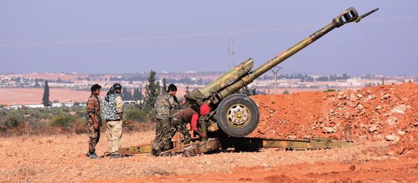 Syrian pro-government fighters fire a Russian 122mm howitzer gun as they advance in the recently recaptured village of Joubah during an offensive towards the area of Al-Bab in Aleppo province, on November 25, 2016 - Sputnik International