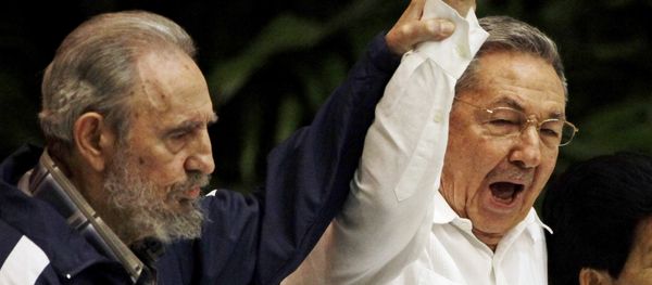 Fidel Castro, left, raises his brother's hand, Cuba's President Raul Castro, center, as they sing the anthem of international socialism during the 6th Communist Party Congress in Havana, Cuba (File) Fidel Castro, left, raises his brother's hand, Cuba's President Raul Castro, center, as they sing the anthem of international socialism during the 6th Communist Party Congress in Havana, Cuba (File) - Sputnik International