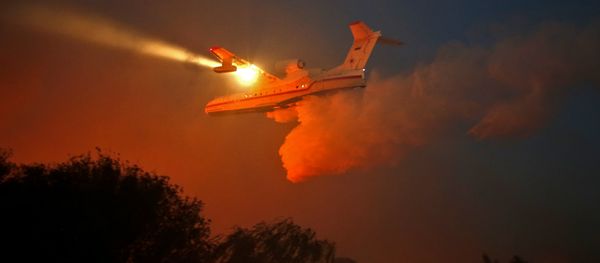 A Russian firefighter plane helps extinguish a new fire that broke out in the Israeli town of Nataf, west of the Arab Israeli town of Abu Ghosh, along the border with the occupied West Bank on November 25, 2016 - Sputnik International