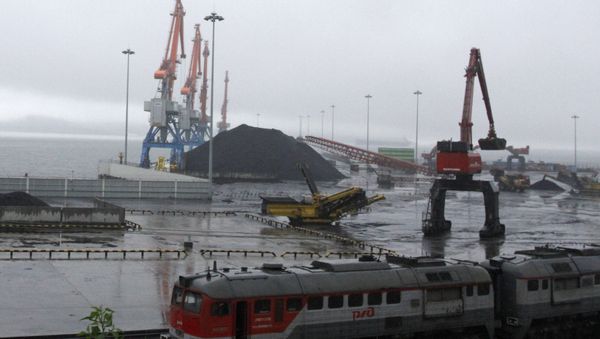 In this July 24, 2016 photo, coal brought from Siberia are be seen awaiting loading onto a ship bound for China in the North Korean special economic zone of Rason In this July 24, 2016 photo, coal brought from Siberia are be seen awaiting loading onto a ship bound for China in the North Korean special economic zone of Rason - Sputnik International