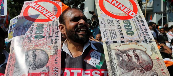 A man holds placards and shouts slogans during a rally organized by India's main opposition Congress party against the government's decision to withdraw 500 and 1000 Indian rupee banknotes from circulation, in Mumbai, India November 28, 2016. A man holds placards and shouts slogans during a rally organized by India's main opposition Congress party against the government's decision to withdraw 500 and 1000 Indian rupee banknotes from circulation, in Mumbai, India November 28, 2016. - Sputnik International