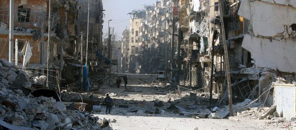 Syrians walk over rubble of damaged buildings, while carrying their belongings, as they flee clashes between government forces and rebels in Tariq al-Bab and al-Sakhour neighborhoods of eastern Aleppo - Sputnik International