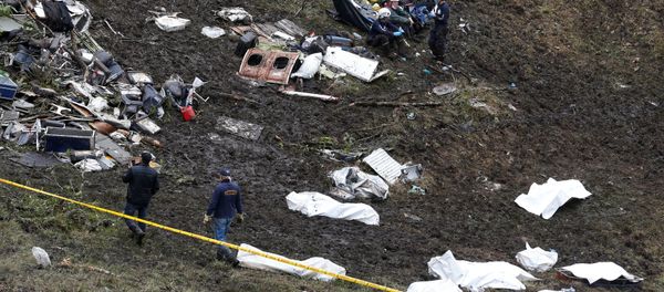 Rescue workers walk next to bodies from the wreckage of a plane that crashed into the Colombian jungle with the Brazilian soccer team Chapecoense onboard near Medellin, Colombia - Sputnik International