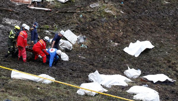 Rescue workers carry the body of a victim from a plane that crashed into Colombian jungle with Brazilian soccer team Chapecoense, near Medellin, Colombia - Sputnik International