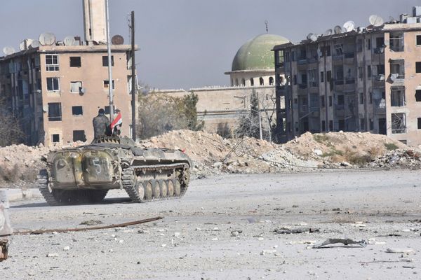 A Syrian government soldier rides a military vehicle near a mosque, after taking control of Aleppo's Al-Haidariya neighbourhood, Syria. (File) - Sputnik International