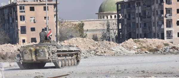 A Syrian government soldier rides a military vehicle near a mosque, after taking control of Aleppo's Al-Haidariya neighbourhood, Syria in this handout picture provided by SANA on November 28, 2016. - Sputnik International