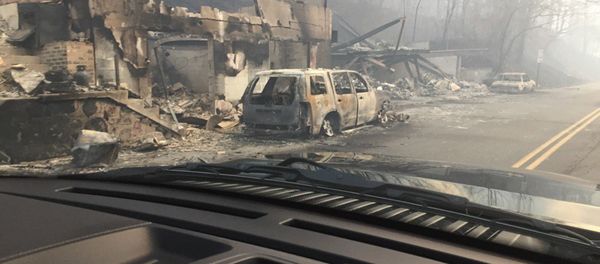 Burned buildings and cars aftermath of wildfire is seen in this image released in social media by Tennessee Highway Patrol in Gatlinburg, Tennessee, U.S. on November 29, 2016 Burned buildings and cars aftermath of wildfire is seen in this image released in social media by Tennessee Highway Patrol in Gatlinburg, Tennessee, U.S. on November 29, 2016 - Sputnik International