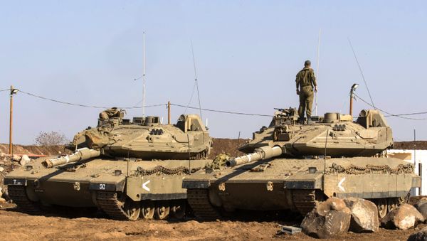 An Israeli soldier stands on top of a Merkava tank near the border with Syria in the Israeli-annexed Golan Heights, on November 28, 2016 An Israeli soldier stands on top of a Merkava tank near the border with Syria in the Israeli-annexed Golan Heights, on November 28, 2016 - Sputnik International