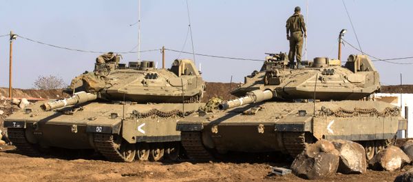 An Israeli soldier stands on top of a Merkava tank near the border with Syria in the Israeli-annexed Golan Heights, on November 28, 2016 - Sputnik International