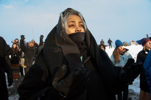 A woman watches the sunrise in Oceti Sakowin camp as water protectors continue to demonstrate against plans to pass the Dakota Access pipeline near the Standing Rock Indian Reservation, near Cannon Ball, North Dakota, U.S. December 3, 2016 - Sputnik International